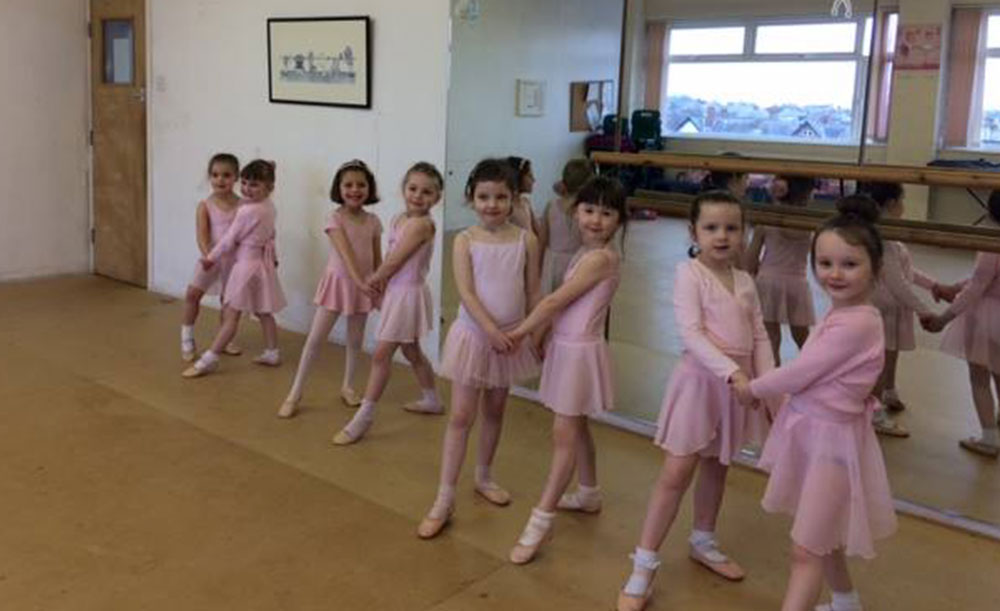 children in pink ballet outfits